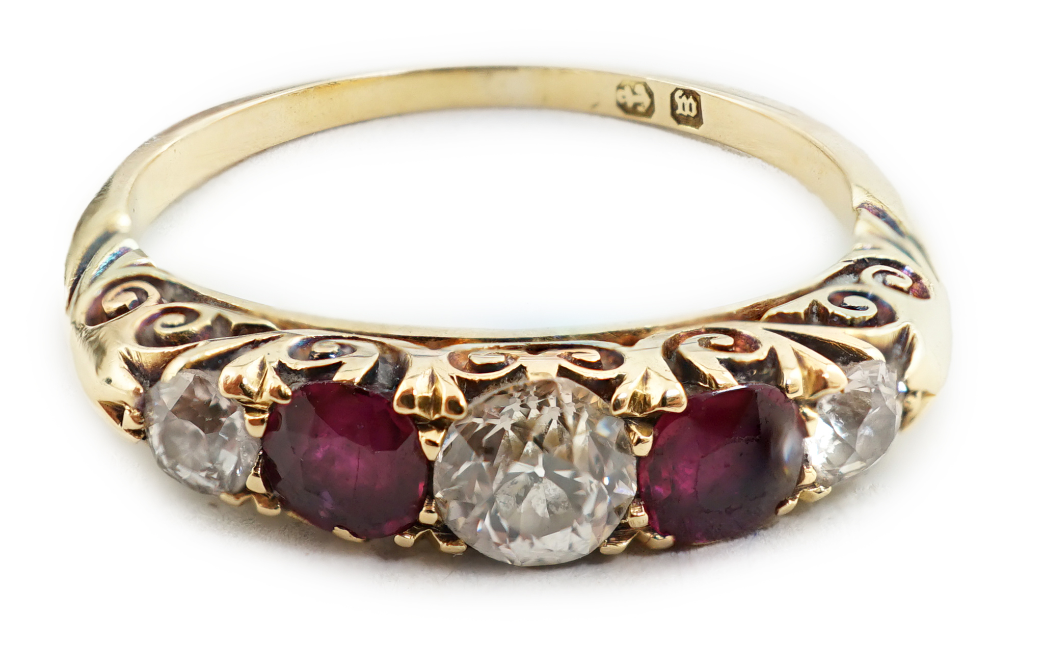 A late Victorian gold, three stone diamond and two stone ruby set half hoop ring